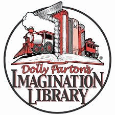 A row of books held up by two halves of a train bookends, sitting on an open book. Dolly Parton's Imagination Library